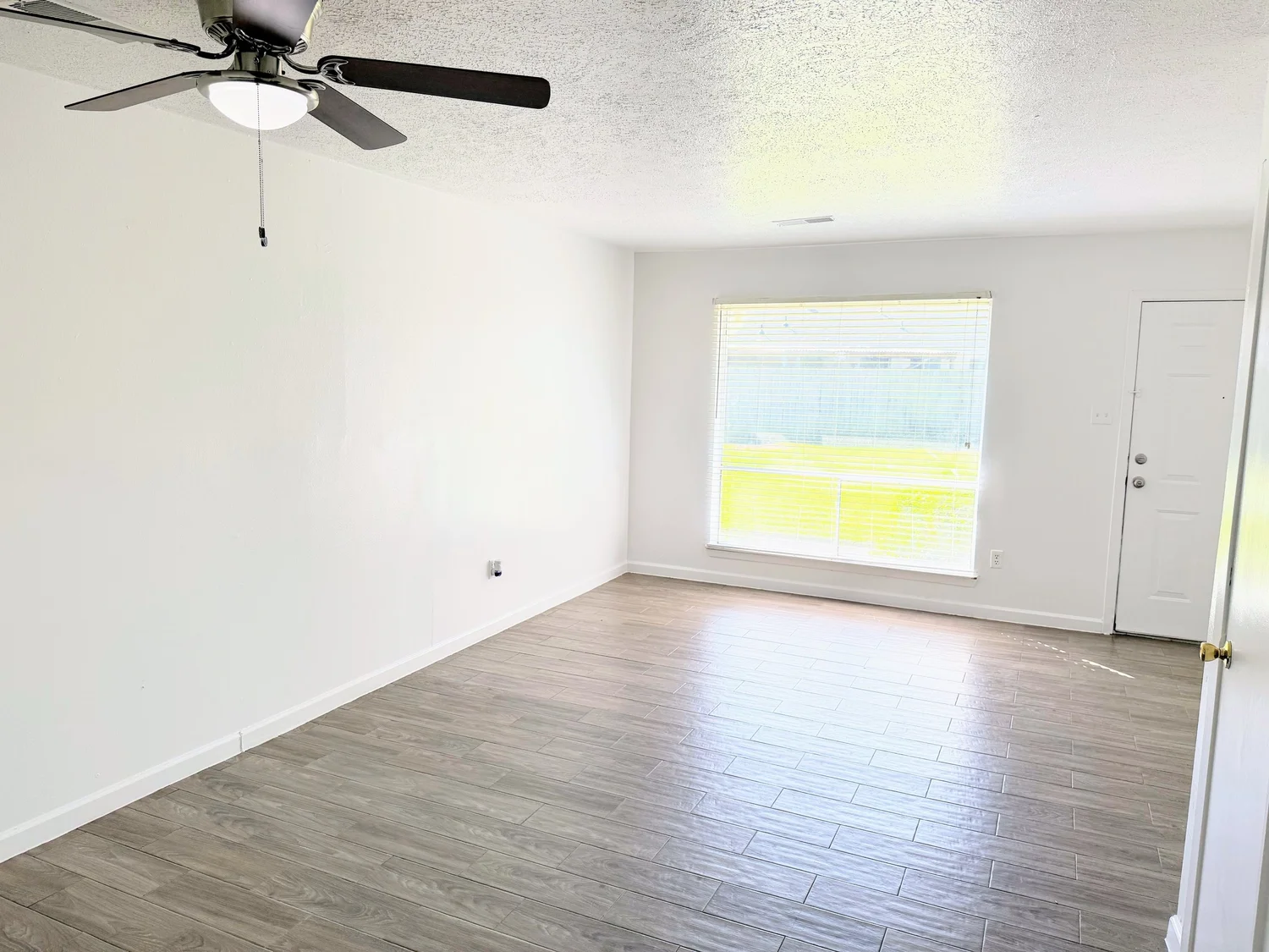 Bright living room with tile wood-finish flooring